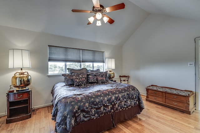 bedroom with ceiling fan, a baseboard heating unit, light hardwood / wood-style flooring, and vaulted ceiling