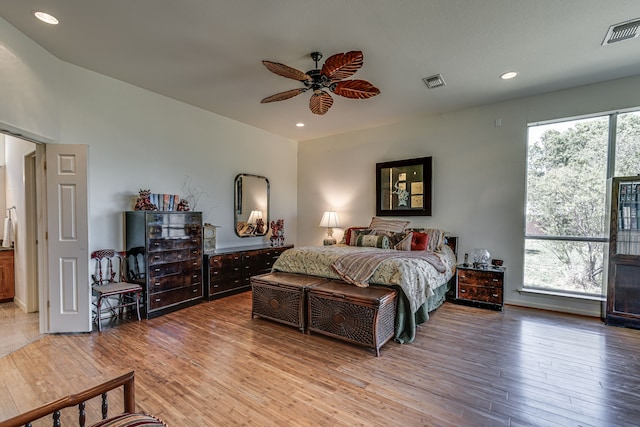 bedroom featuring multiple windows, wood finished floors, and visible vents