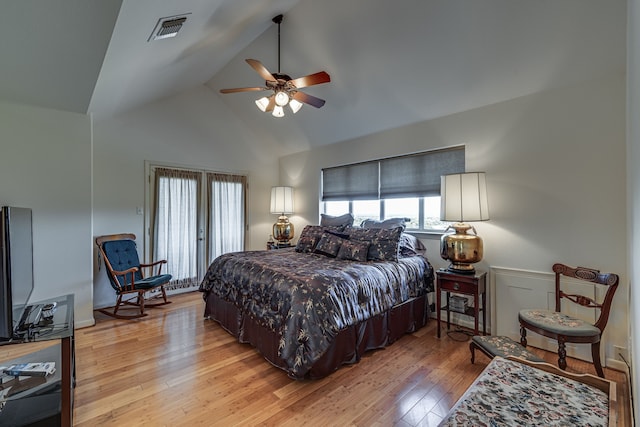 bedroom with ceiling fan, lofted ceiling, and light hardwood / wood-style flooring