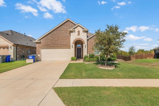 view of front of house featuring a front yard and a garage