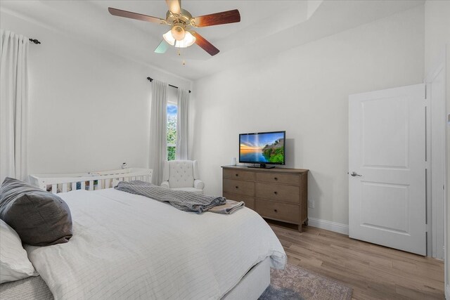 bedroom with ceiling fan and light wood-type flooring