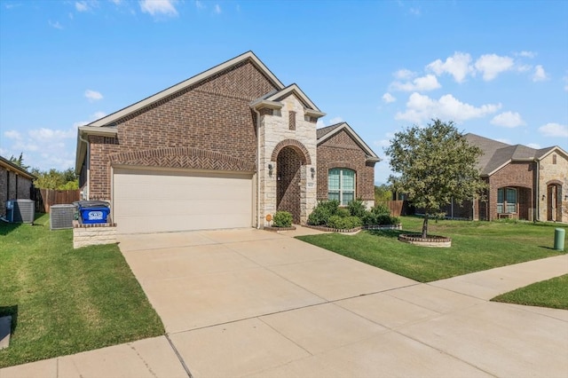 view of front of home featuring a front yard, cooling unit, and a garage