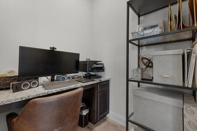 office area featuring light hardwood / wood-style flooring and built in desk