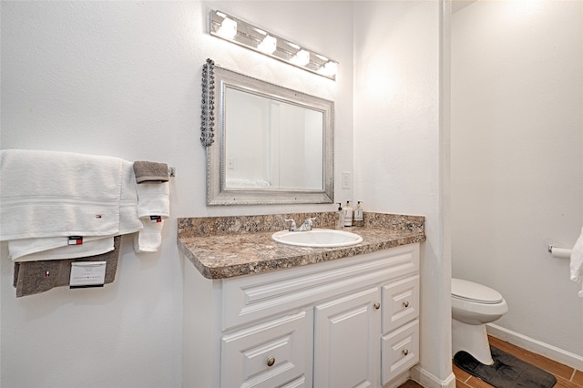 bathroom with vanity, wood-type flooring, and toilet