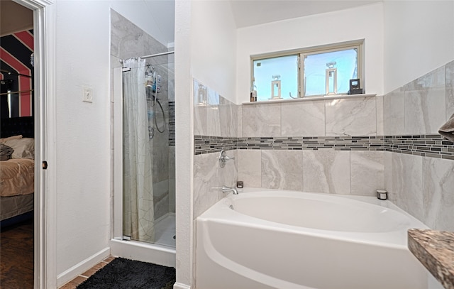 bathroom featuring separate shower and tub