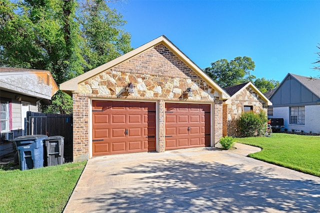 view of front facade with an outbuilding, a front yard, and a garage