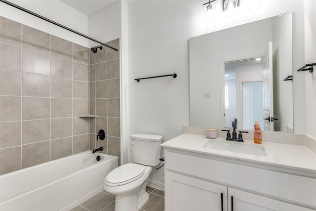 full bathroom featuring tile patterned floors, tiled shower / bath combo, toilet, and vanity