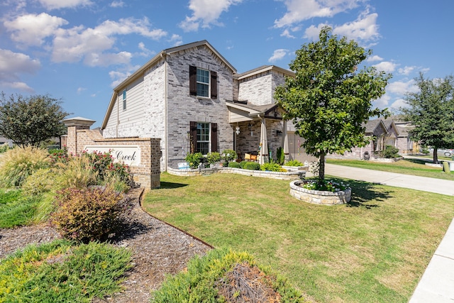 view of front of property with a front yard and a garage