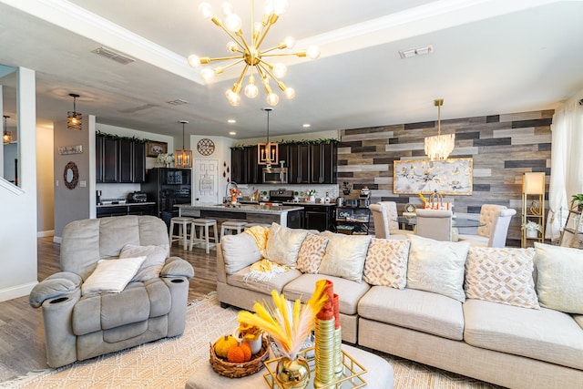 living room with light hardwood / wood-style flooring and a chandelier