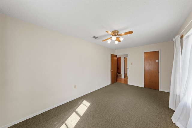 unfurnished room with ceiling fan and carpet