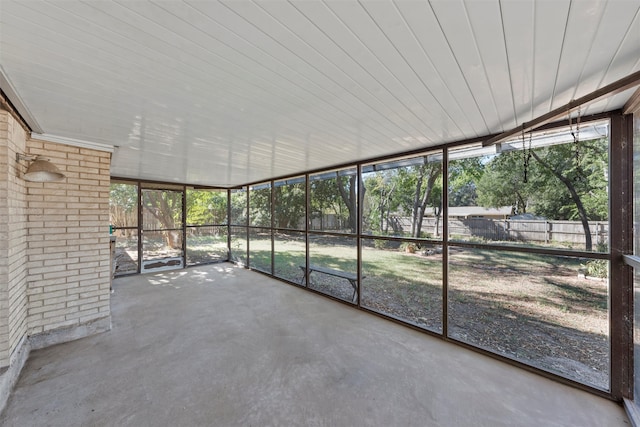 unfurnished sunroom with wooden ceiling