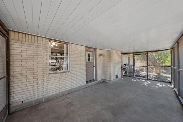 unfurnished sunroom featuring wood ceiling