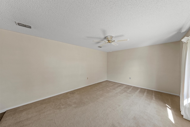 unfurnished room with a textured ceiling, ceiling fan, and light colored carpet