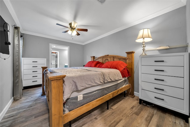 bedroom with crown molding, ceiling fan, and dark hardwood / wood-style floors