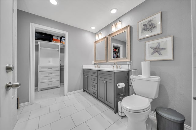 bathroom featuring tile patterned floors, vanity, and toilet