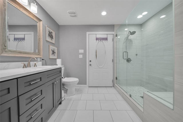 bathroom featuring tile patterned flooring, walk in shower, vanity, and toilet