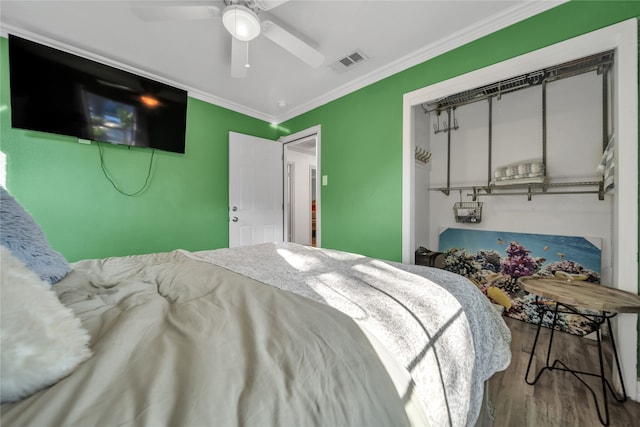 bedroom with ceiling fan, hardwood / wood-style floors, and ornamental molding