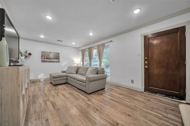 living room featuring light wood-type flooring and crown molding