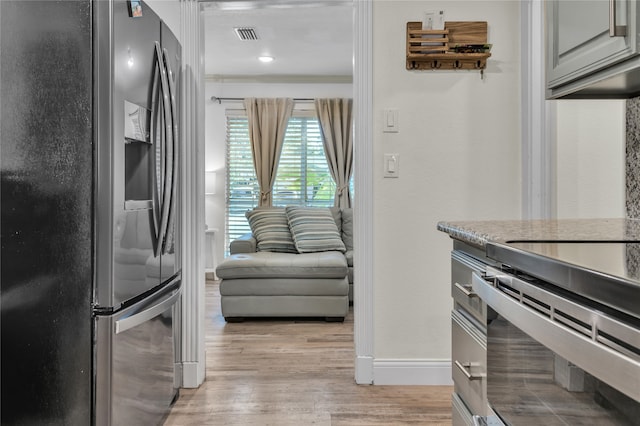 kitchen featuring stainless steel appliances and light hardwood / wood-style floors