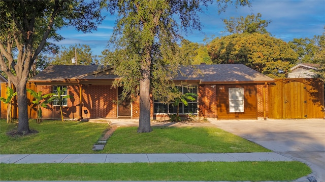 ranch-style home with a front lawn