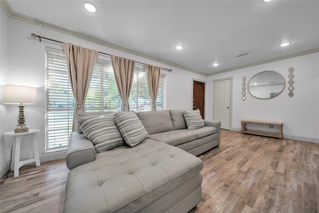 living room with light wood-type flooring and ornamental molding