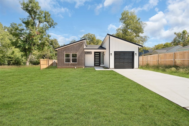 view of front of property with a garage and a front lawn