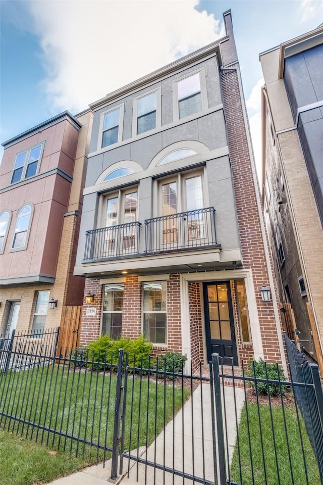 multi unit property featuring a balcony and a front yard