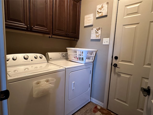 laundry room featuring cabinets and washing machine and dryer