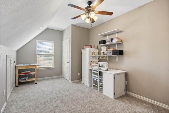 carpeted office with a textured ceiling, ceiling fan, and lofted ceiling