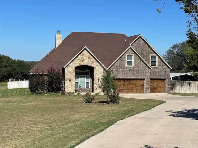 view of front of home featuring a front lawn and a garage