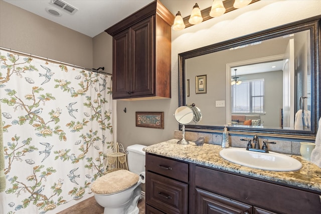 bathroom featuring tile patterned flooring, vanity, curtained shower, and toilet