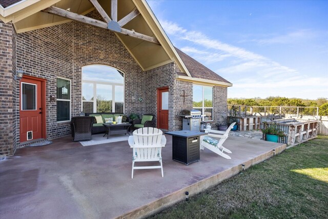 view of patio featuring a grill and an outdoor living space with a fire pit