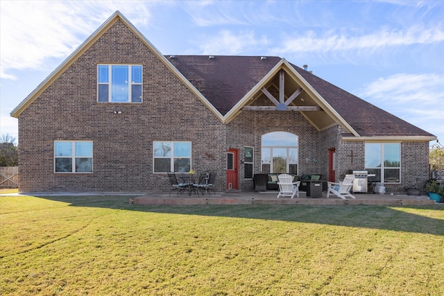 back of house featuring a yard and a patio area