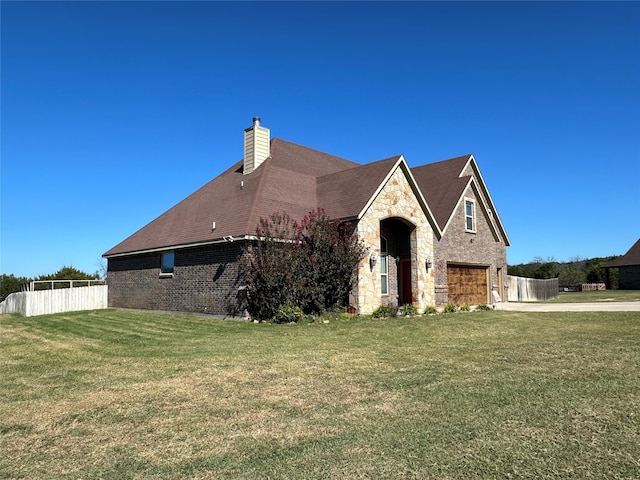 view of front of home with a front yard and a garage