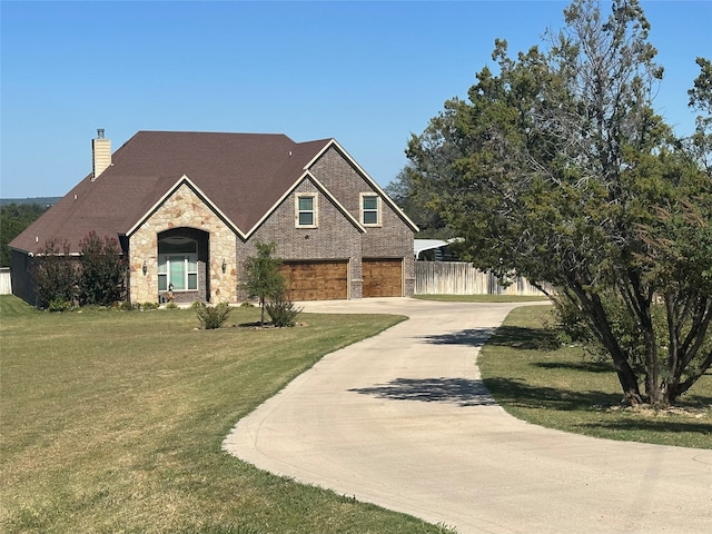 view of front facade with a garage and a front lawn