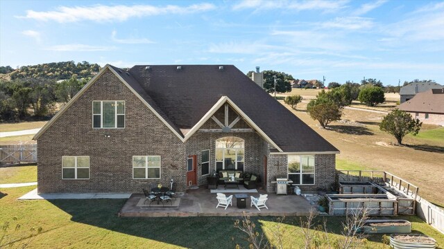 back of house with a patio area, a yard, and an outdoor hangout area