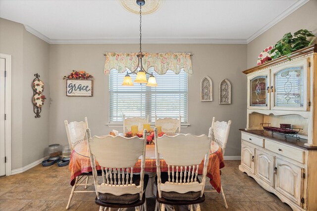 dining area with a notable chandelier and crown molding