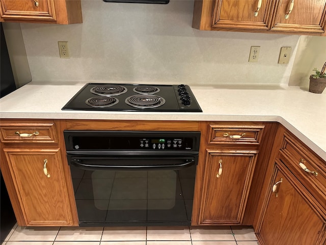 kitchen featuring black appliances and light tile patterned flooring