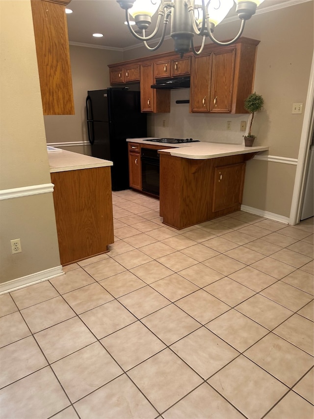 kitchen with ornamental molding, kitchen peninsula, an inviting chandelier, black refrigerator, and gas stovetop