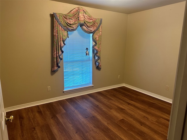 empty room featuring dark hardwood / wood-style flooring