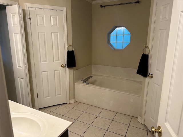 bathroom featuring tile patterned flooring, vanity, and a tub