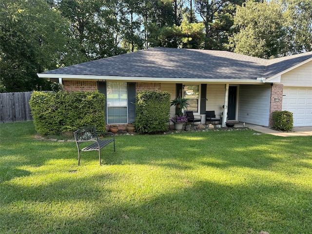 single story home featuring a front yard, a garage, and covered porch