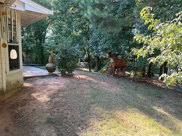 view of yard with a playground and a patio area