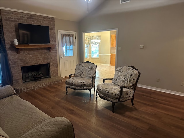 sitting room featuring a fireplace, vaulted ceiling, and dark hardwood / wood-style flooring