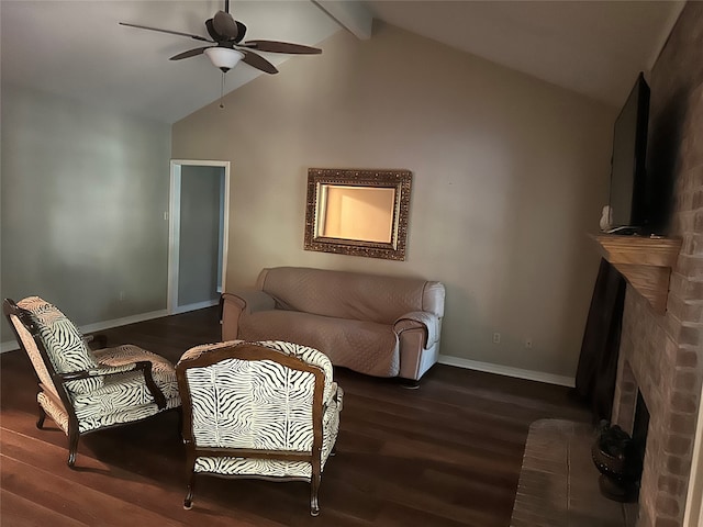 sitting room with lofted ceiling with beams, a brick fireplace, ceiling fan, and dark hardwood / wood-style flooring