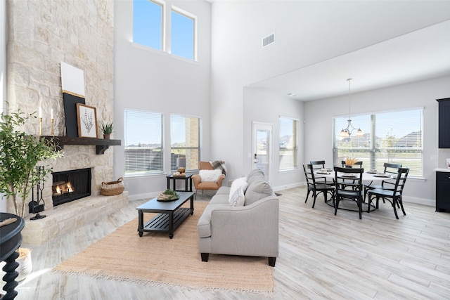 living room with a wealth of natural light, light hardwood / wood-style floors, and a fireplace