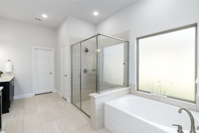 bathroom with vanity, shower with separate bathtub, and tile patterned flooring