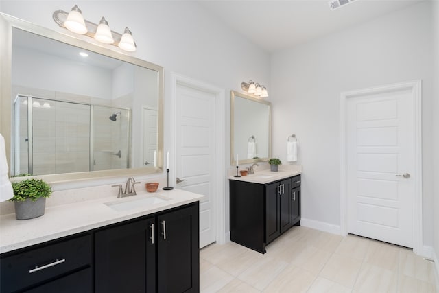 bathroom featuring vanity, an enclosed shower, and tile patterned floors