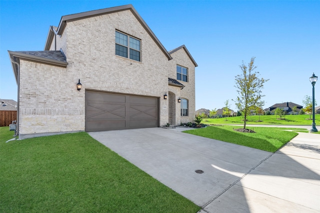 view of front of property with a front yard and a garage