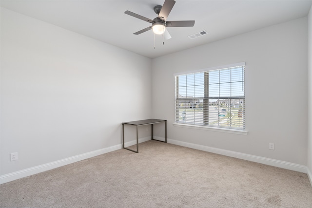 carpeted empty room featuring ceiling fan